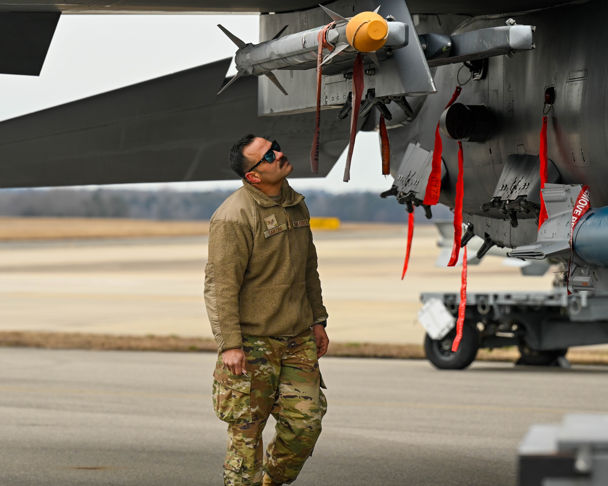 U.S. Air Force Staff Sgt. Carlos Santini, a weapons standardization crew member assigned to the 4th Maintenance Group, inspects munitions during a quarterly load crew competition at Seymour Johnson Air Force Base, North Carolina, Jan. 10, 2025. The purpose of the competition is to motivate and train Airmen to quickly and efficiently load munitions on aircraft for deployments and real world operations. (U.S. Air Force photo by Airman 1st Class Rebecca Tierney)