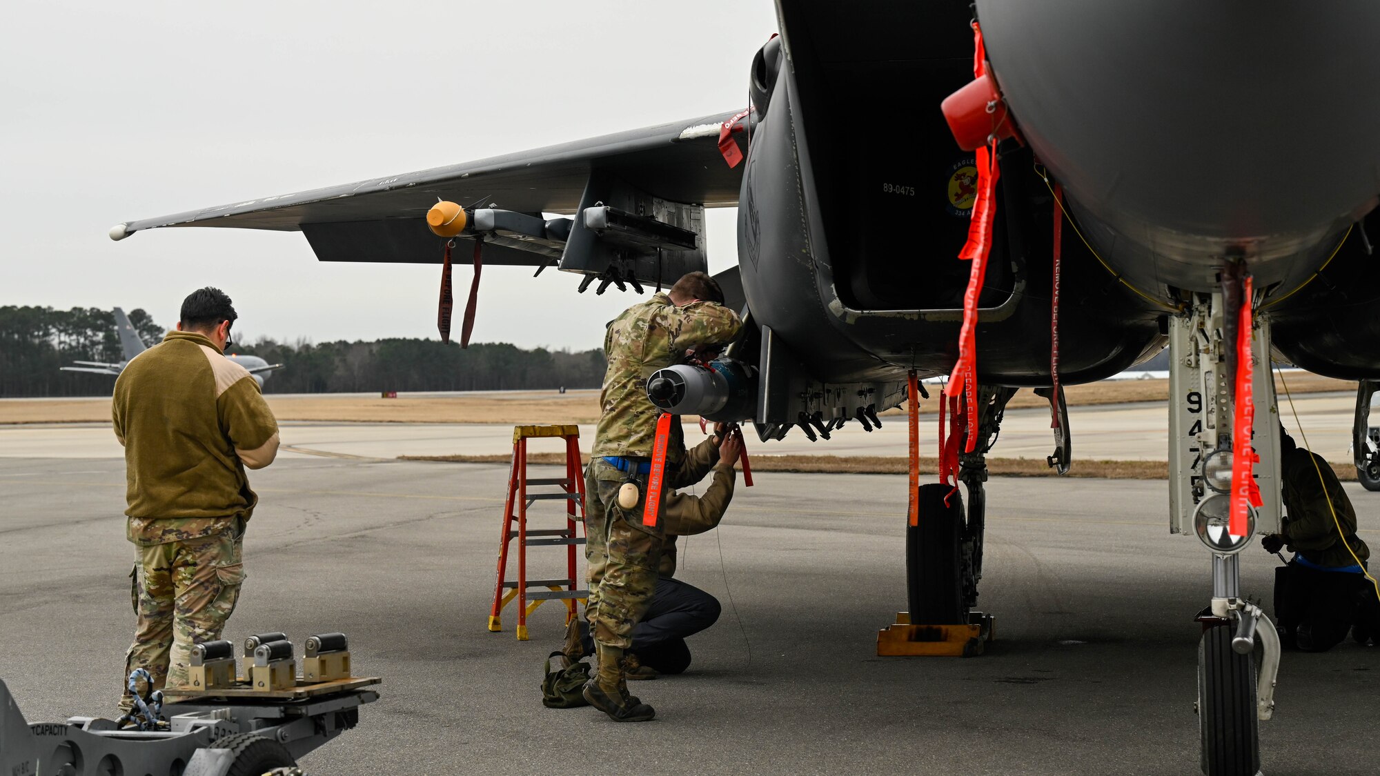 U.S. Airmen assigned to the 334th Fighter Generation Squadron participate in a quarterly load crew competition at Seymour Johnson Air Force Base, North Carolina, Jan. 10, 2025. Each quarter, load crews from each unit compete against each other in a timed competition that tests their dress and appearance, weapons knowledge and speed and accuracy of loading munitions on an F-15E Strike Eagle. (U.S. Air Force photo by Airman 1st Class Rebecca Tierney)