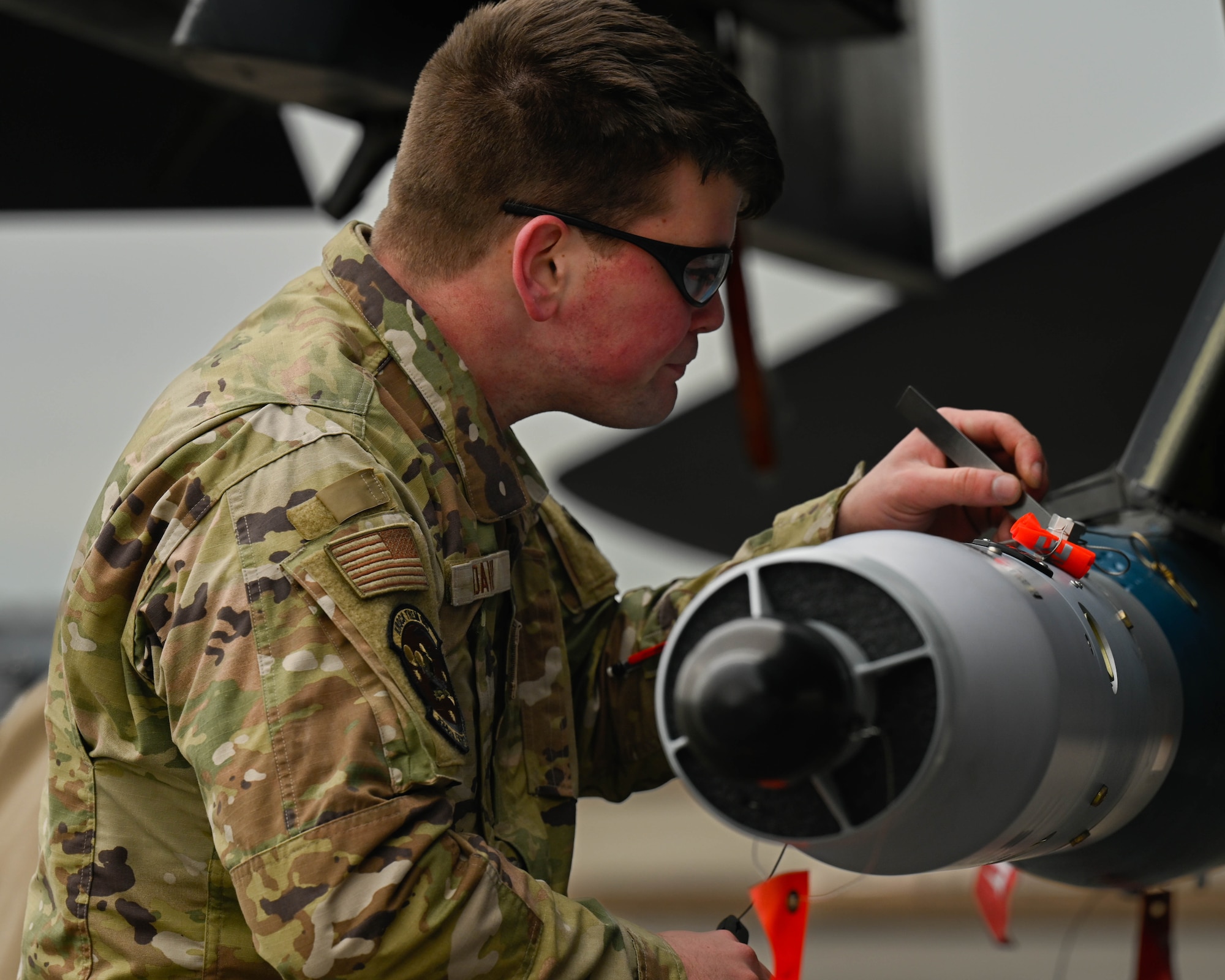 U.S. Air Force Senior Airman Garity Daily, a weapons load crew member assigned to the 334th Fighter Generation Squadron, loads munitions during a quarterly load crew competition at Seymour Johnson Air Force Base, North Carolina, Jan. 10, 2025. The purpose of the competition is to motivate and train Airmen to quickly and efficiently load munitions on aircraft for deployments and real world operations. (U.S. Air Force photo by Airman 1st Class Rebecca Tierney)