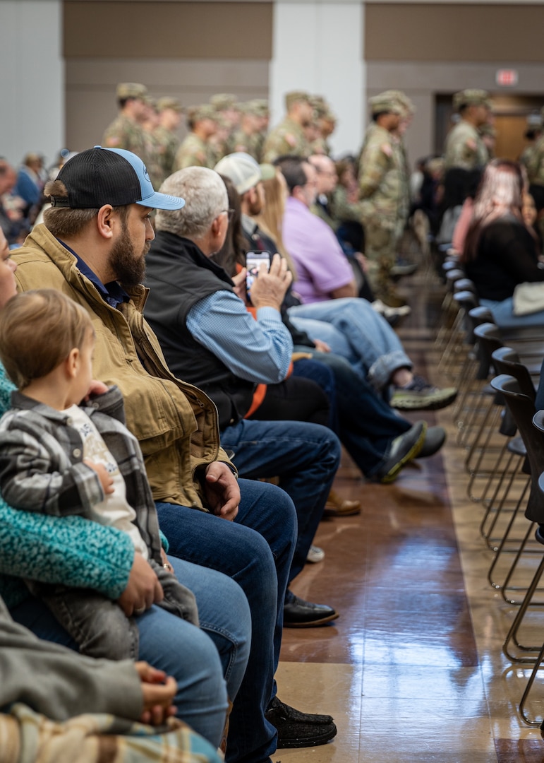 Friends and family look on during a farewell ceremony for the 1120th Engineer Utilities Detachment at the Muskogee Readiness Center in Muskogee, Oklahoma, Jan. 13, 2025. Approximately 50 Soldiers will deploy overseas in support of United States Africa Command area of responsibility where they will take part in engineering and utilities projects across the Horn of Africa. (Oklahoma National Guard photo by Spc. Danielle Rayon)