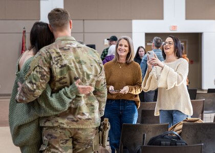 Soldiers and family members embrace during a farewell ceremony for the 1120th Engineer Utilities Detachment at the Muskogee Readiness Center in Muskogee, Oklahoma, Jan. 13, 2025. Approximately 50 Soldiers will deploy overseas in support of United States Africa Command area of responsibility where they will take part in engineering and utilities projects across the Horn of Africa. (Oklahoma National Guard photo by Spc. Danielle Rayon)