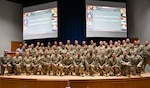 U.S. Air Force leaders in enlisted education pose inside of Spruance Hall at the I.G. Brown Training and Education Center, McGhee Tyson Air National Guard Base, Tennessee, Jan. 8, 2025. Airman Leadership School commandants, senior leaders from the Barnes Center for Enlisted Education and representatives from the Lankford Center for Enlisted Professional Military Education attend the inaugural ALS Commandant's Conference to share strategies and best practices to develop the next generation of Total Force enlisted leaders.