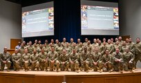 U.S. Air Force leaders in enlisted education pose inside of Spruance Hall at the I.G. Brown Training and Education Center, McGhee Tyson Air National Guard Base, Tennessee, Jan. 8, 2025. Airman Leadership School commandants, senior leaders from the Barnes Center for Enlisted Education and representatives from the Lankford Center for Enlisted Professional Military Education attend the inaugural ALS Commandant's Conference to share strategies and best practices to develop the next generation of Total Force enlisted leaders.