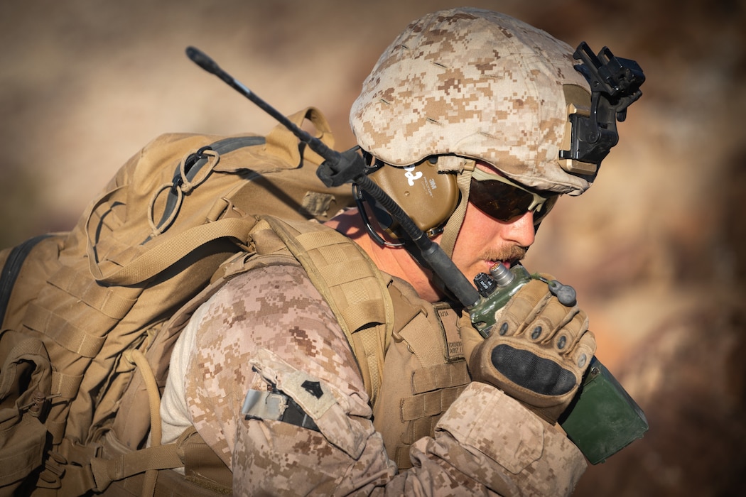 U.S. Marine Corps Sgt. Jacob L. Dewey, platoon sergeant, Echo Company, 2nd Battalion, 24th Marine Regiment, 4th Marine Division, Marine Forces Reserve, calls in a medical evacuation for a simulated scenario where a Marine is shot in the chest during range 410 alpha at Marine Corps Air-Ground Combat Center Twentynine Palms, California, June 13, 2024. ITX is a live-fire and maneuver combined arms exercise designed to train battalion and squadron-sized units in tactics, techniques, and procedures that provides a sustainable and ready operational Reserve force. (U.S. Marine Corps photo by Lance Cpl. Orion Stpierre)