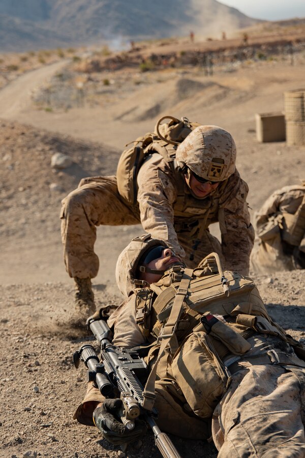 U.S. Marines with 2nd Battalion, 24th Marine Regiment, 4th Marine Division, Marine Forces Reserve, pulls a notional casualty to safety during range 400, Integrated Training Exercise 4-24 at Marine Corps Air-Ground Combat Center, Twentynine Palms, California, June 16, 2024. Range 400 is used to train rifle companies in the techniques and procedures for attacking fortified areas. ITX is the culmination of Marine Forces Reserve’s training cycle as they participate in a live-fire, combined arms exercise as a part of MAGTF operating over vast distances. (U.S. Marine Corps photo by Lance Cpl. Orion Stpierre)