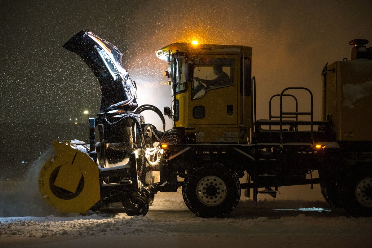 A snowplow removes snow from the flight line.