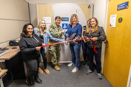 Capt. JD Crinklaw, left, commander, Puget Sound Naval Shipyard & Intermediate & Intermediate Maintenance Facility, participates in an official ribbon-cutting ceremony inside Building 844, Nov. 22, 2024, for one of three new expressing station pods to support nursing mothers working at PSNS & IMF in Bremerton, Washington. (U.S. Navy photo by Jeb Fach)