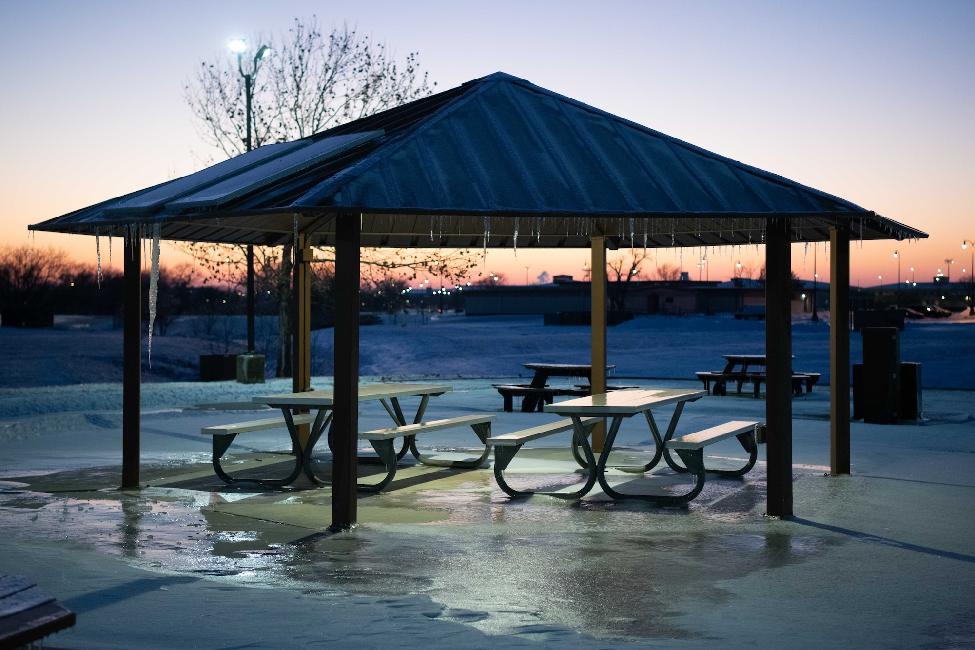 An ice-covered gazebo glows in the sunset at McConnell Air Force Base, Kansas, Jan. 8, 2025. Over the course of five days, approximately nine inches of snowfall covered the surrounding area of Sedgwick County. (U.S. Air Force photo by Airman 1st Class Patrick O'Neill)