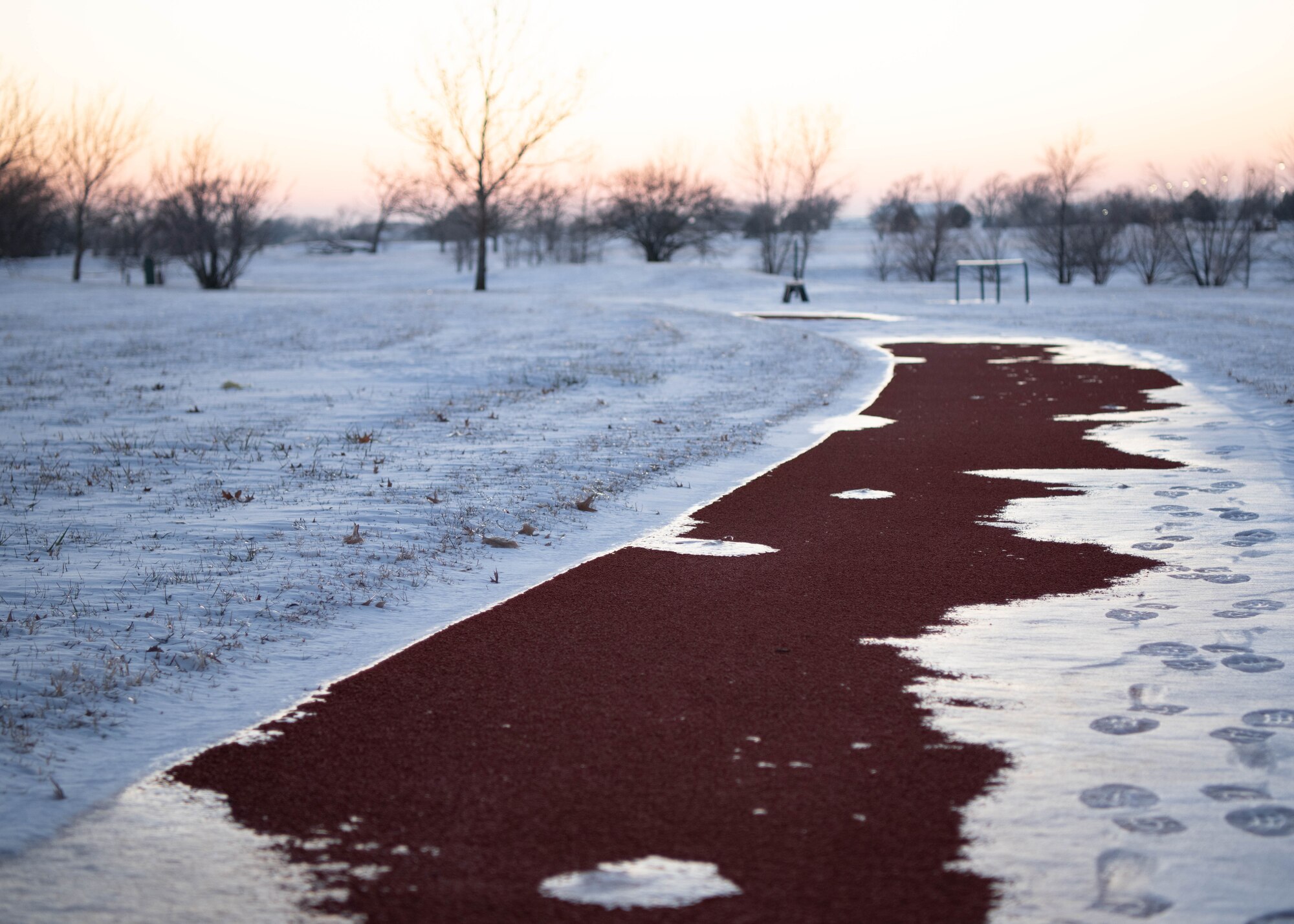 Ice covers an outdoor running path at McConnell Air Force Base, Kansas, Jan. 8, 2025. Over the course of five days, approximately nine inches of snowfall covered the surrounding area of Sedgwick County. (U.S. Air Force photo by Airman 1st Class Patrick O'Neill)