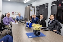 Manuel Hermosilla, deputy commander, Cyber Engineering & Digital Transformation, NAVSEA03, is briefed on recent innovations by employees in the Puget Sound Naval Shipyard & Intermediate Maintenance Facility Media Lab, Dec. 3, 2024, in Bremerton, Washington. (U.S. Navy photo by Jeb Fach)