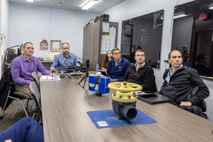 Manuel Hermosilla, deputy commander, Cyber Engineering & Digital Transformation, NAVSEA03, is briefed on recent innovations by employees in the Puget Sound Naval Shipyard & Intermediate Maintenance Facility Media Lab, Dec. 3, 2024, in Bremerton, Washington. (U.S. Navy photo by Jeb Fach)