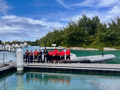 U.S. Coast Guard Forces Micronesia/Sector Guam personnel, supported by Maritime Safety and Security Team (MSST) San Francisco, stand for a photo with CNMI's Department of Public Safety at Smiley Cove in Saipan, CNMI, on Dec. 3, 2024.