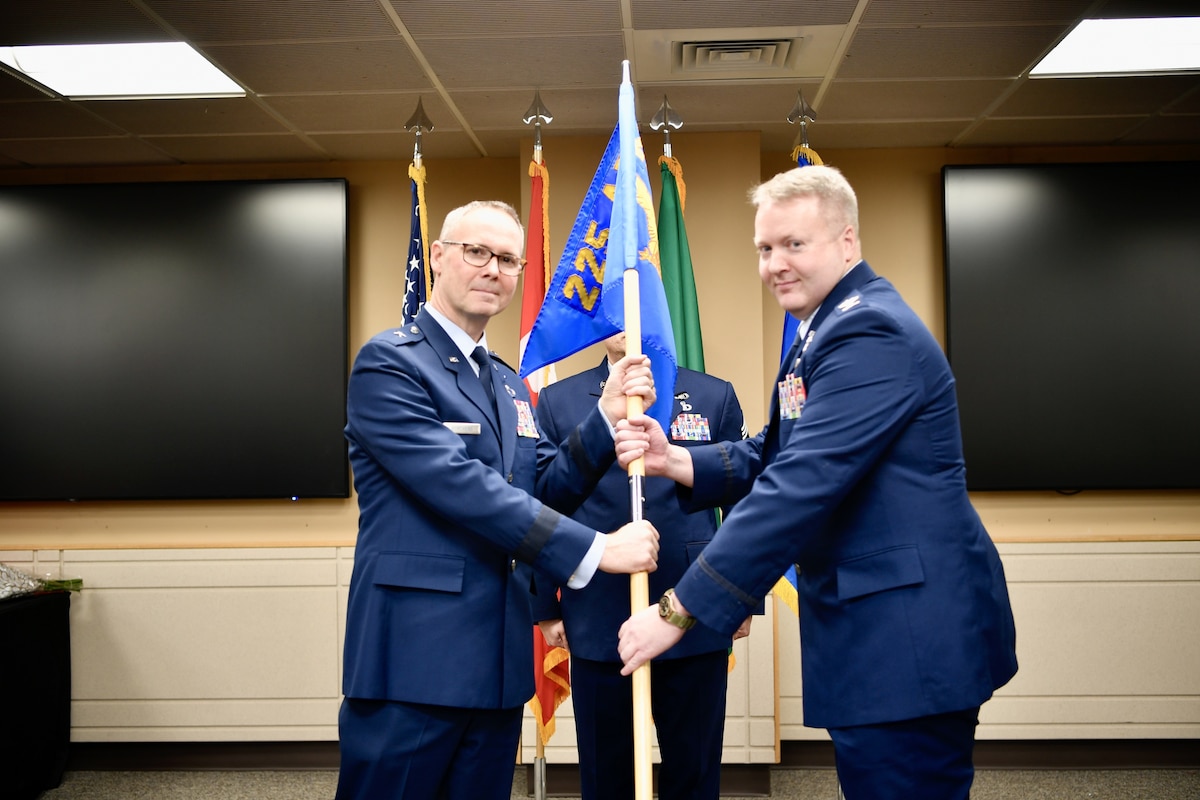 Unit guidon is passed between presiding officer and incoming 225th Air Defense Group commander.