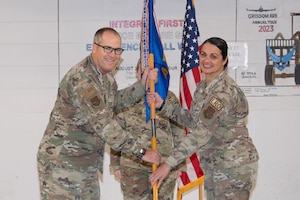 Col. David Borden, 434th Mission Support Group commander, passes the 49th Aerial Port Squadron’s guidon to Maj. Yennishan Sanchez.