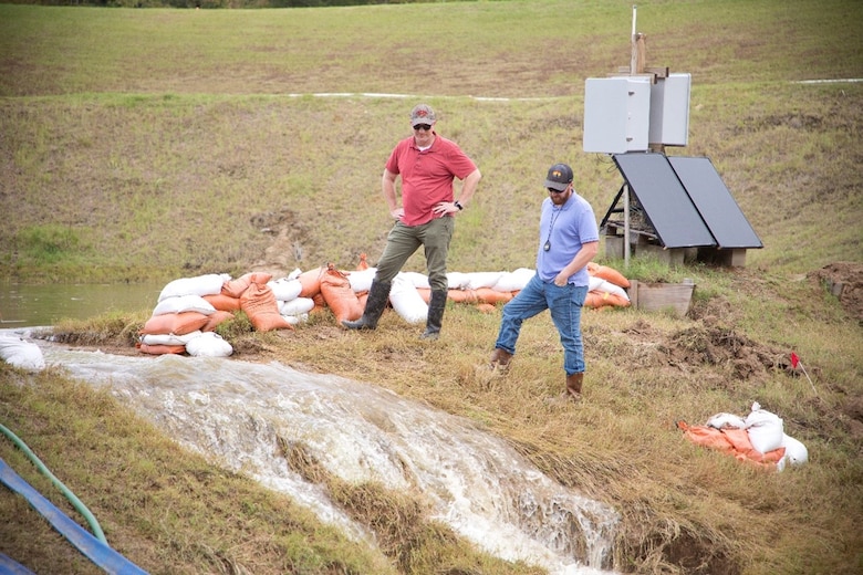 ERDC researchers conduct an overtopping field study of an experimental embankments to evaluate the field performance and application scalability of an extracellular polymeric substance biopolymer.