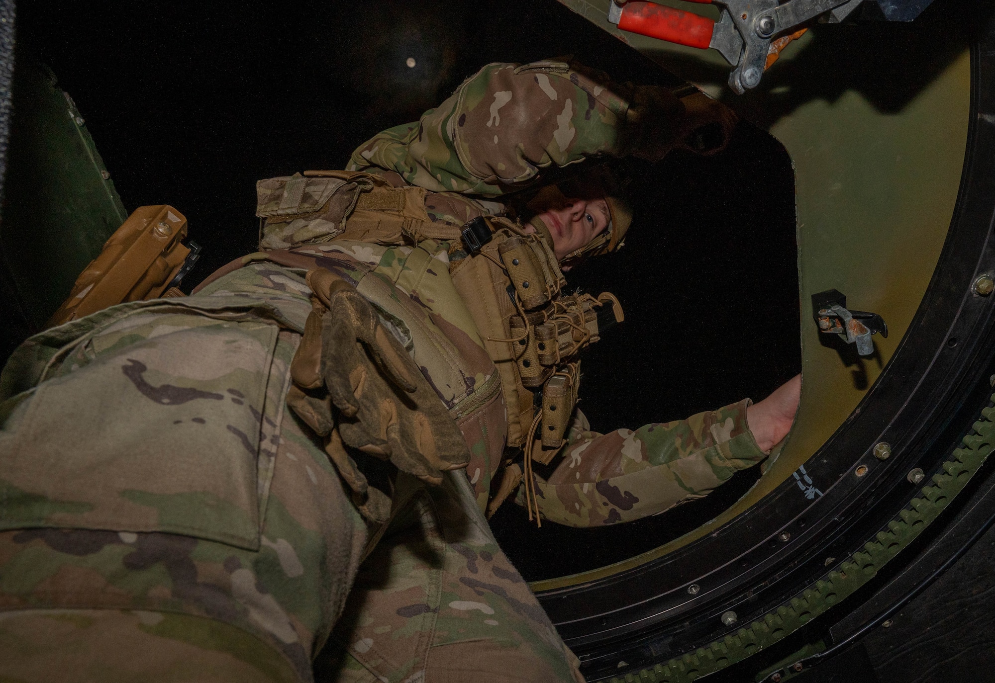 Service member looks down.