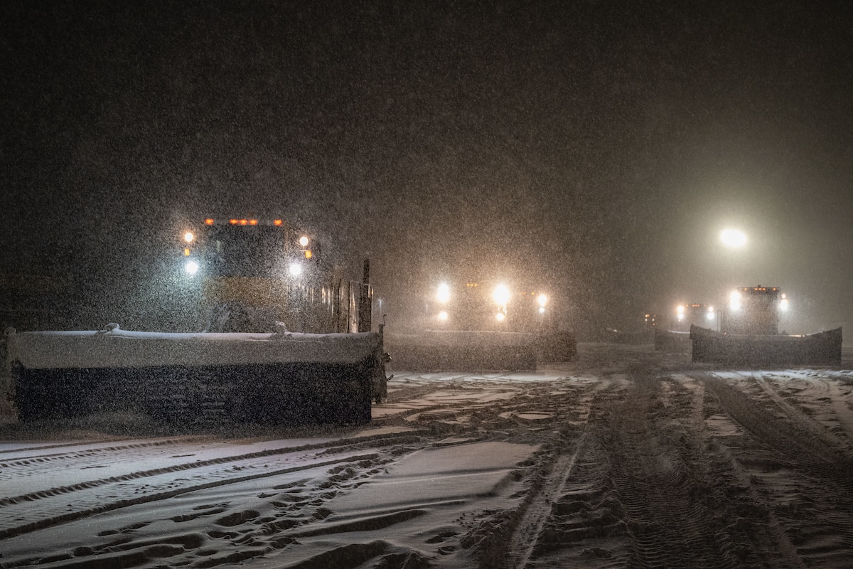snowplows clear snow from the flight line.