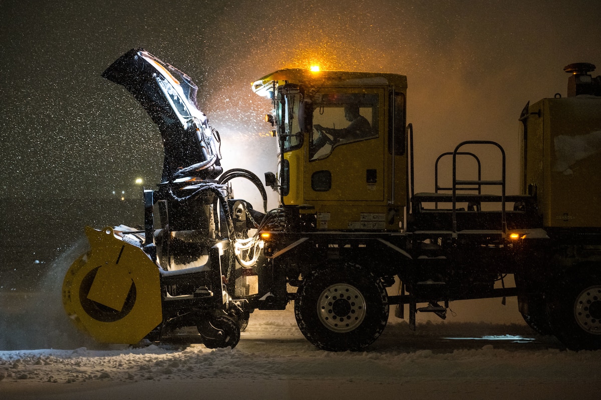 A snowplow removes snow from the flight line.