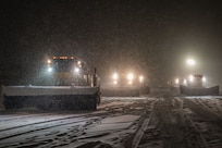 snowplows clear snow from the flight line.