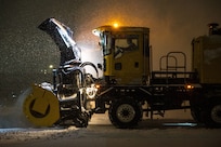 A snowplow removes snow from the flight line.