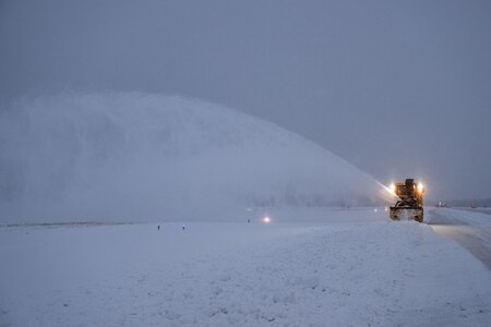 A snowblower removes snow from the flight line.