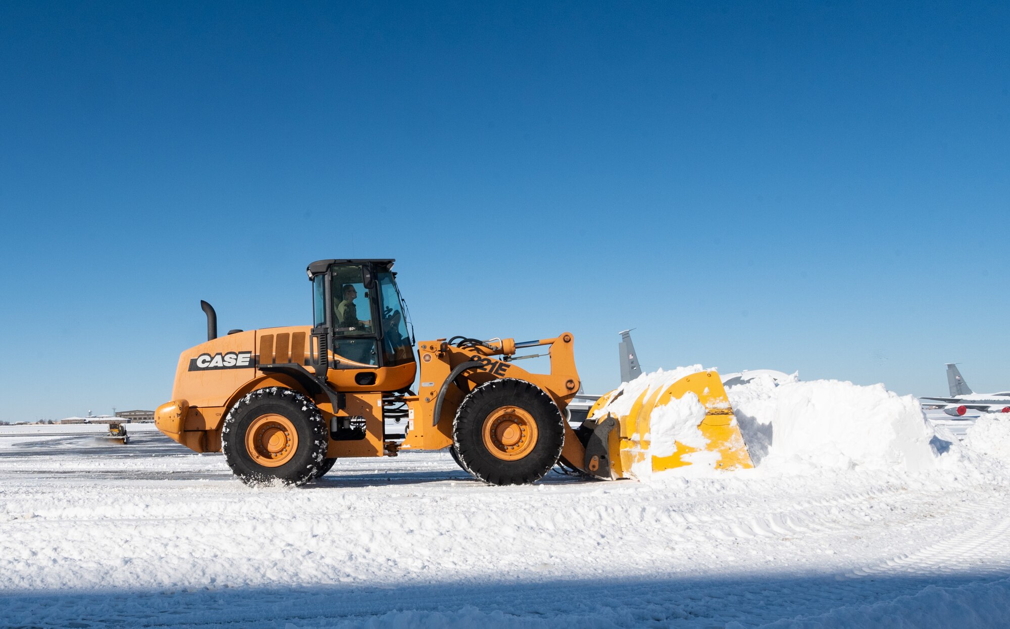 An Airman assigned to the 22nd Civil Engineer Squadron drives a snowplow on the flightline after a winter storm at McConnell Air Force Base, Kansas, Jan. 10, 2025. Over the course of five days, approximately nine inches of snowfall covered the surrounding area of Sedgewick County. (U.S. Air Force photo by Staff Sgt. Tryphena Mayhugh)