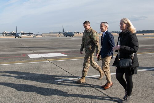 From left, U.S. Air Force Master Sgt. Reid Beimling, 374th Aircraft Maintenance Squadron production superintendent, Lee Ransdell, U.S. Defense Finance and Accounting Service Cleveland director, and Phyllis Ransdell, spouse of Lee Ransdell, walk the flightline.
