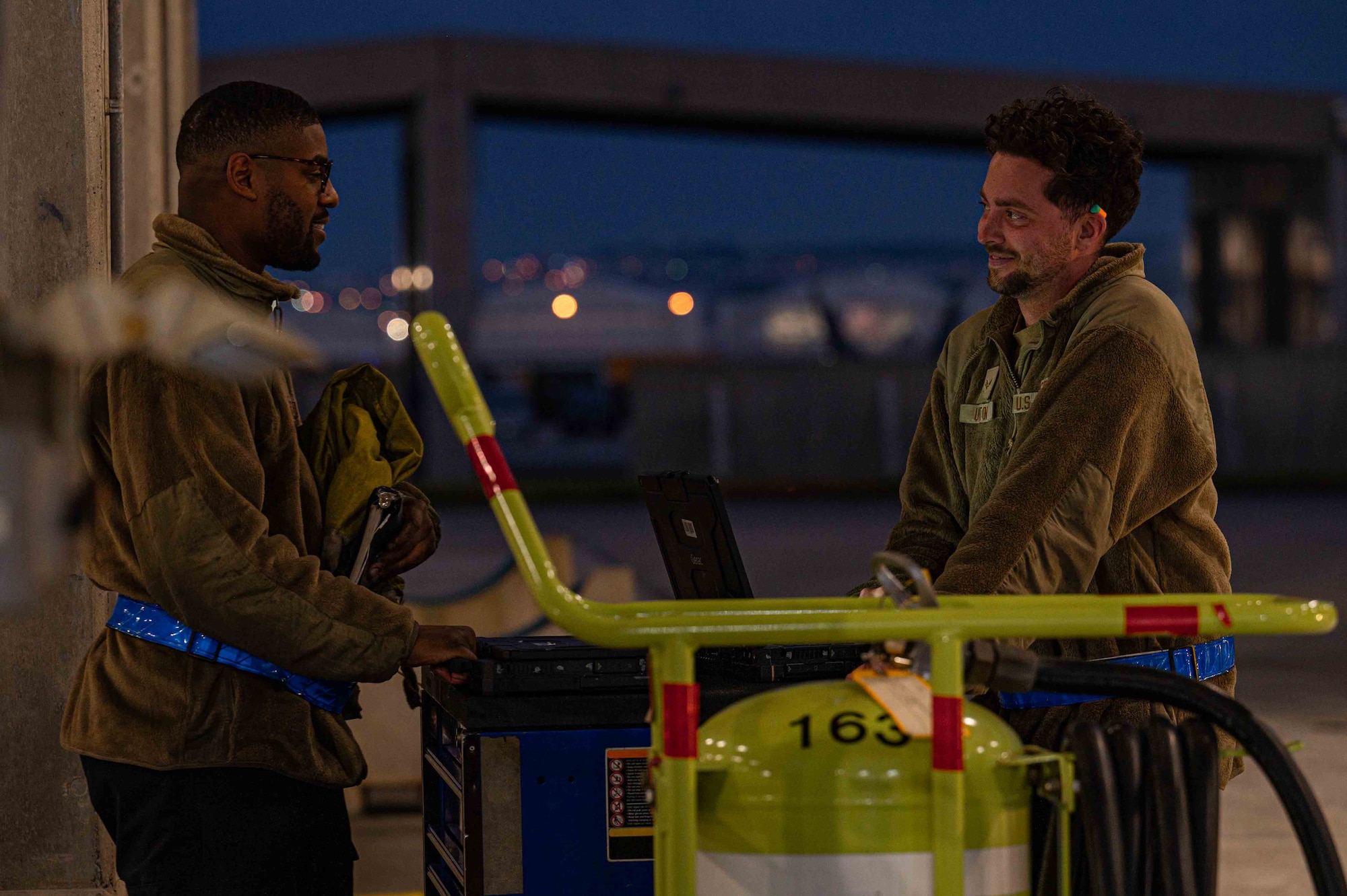 U.S. Air Force Senior Airman Kawan Thornton, left, and Senior Airman Jacob Upton, 525th Fighter Generation Squadron crew chiefs, pack up after pre-flight checks on an F-22A Raptor during a base-wide readiness exercise at Kadena Air Base, Japan, Jan. 15, 2025.