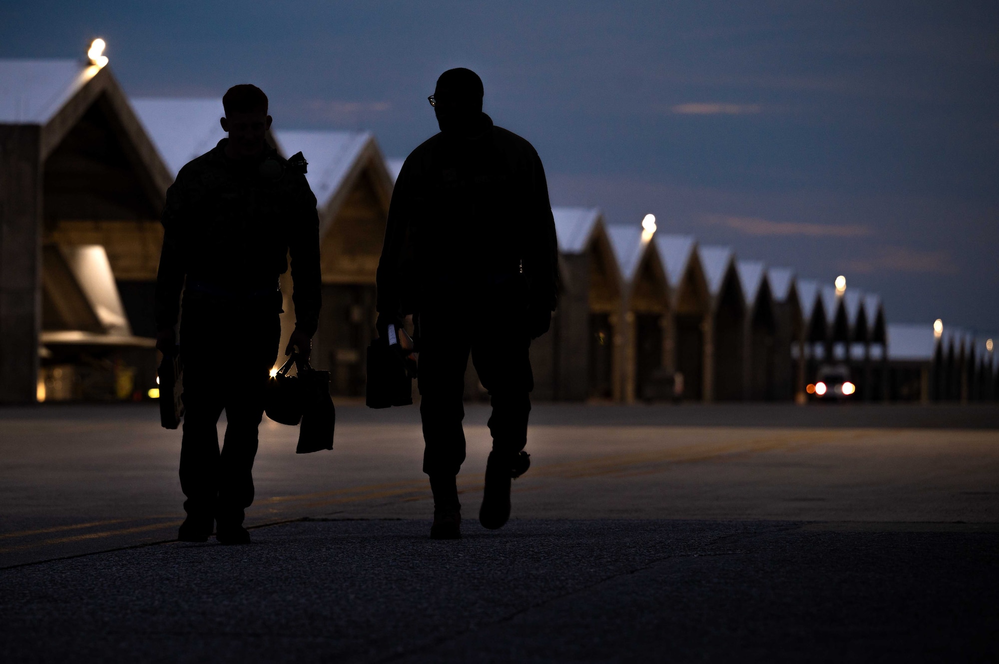 U.S. Air Force crew chiefs with the 525th Fighter Generation Squadron exit the flightline after performing pre-flight checks on an F-22A Raptor during a base-wide readiness exercise at Kadena Air Base, Japan, Jan. 15, 2025.