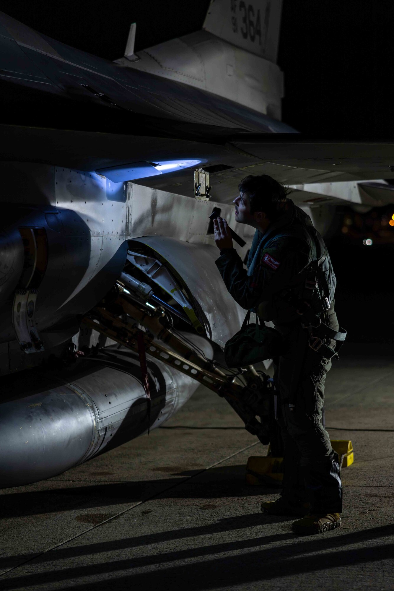 A pilot conducts a pre-flight walk-around of an aircraft.
