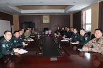 Chief Master Sgt. Brandy Thanos, Master Sgt. Bjorn Nielson, Tech Sgt. James Gilchrest, and Staff Sgt. Steven Laszloffy of the Alaska Air National Guard pose for a photo with their cyber defense counterparts in Mongolia while discussing cyber defense training and information exchange opportunities. The Alaska National Guard and Mongolia are State Partnership Program partners.