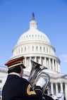 A soldier plays a euphonium in front of U.S. Capitol