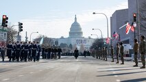 U.S. Coast Guard and U.S. Army honor guardsmen marching with U.S. Capitol in the background