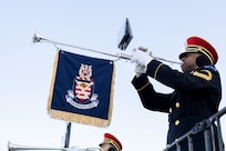A service member plays the trumpet