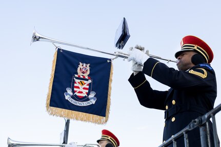 A service member plays the trumpet