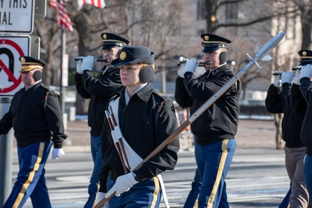 Soldiers from the U.S. Army Old Guard march in formation holding instruments