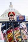 A soldier plays the drum with U.S. Capitol in the background