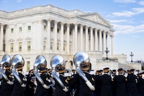 Soldiers march by the U.S. Capitol playing their instruments