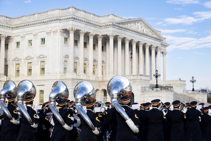 Soldiers march by the U.S. Capitol playing their instruments