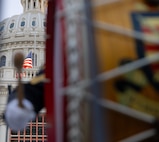 an out of focus drum is played with the U.S. Capitol peeking in the background in focus