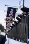 A line of banners from the U.S. Army Band "Pershing's Own" hang off of instruments