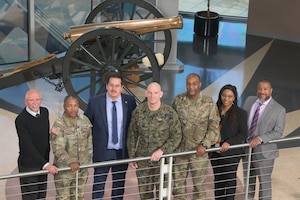 Senior Enlisted Advisor to the Chairman of the Joint Chiefs of Staff Marine Corps Sgt. Maj. Troy E. Black and DLA Senior Enlisted Advisor Air Force Chief Master Sgt. Alvin Dyer, pose for a photo with agency employees who received coins d