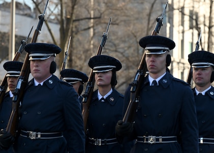 Guardians march while holding rifles