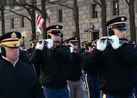 Soldiers playing instruments while marching