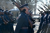 close up of row of Airmen marching holding rifles
