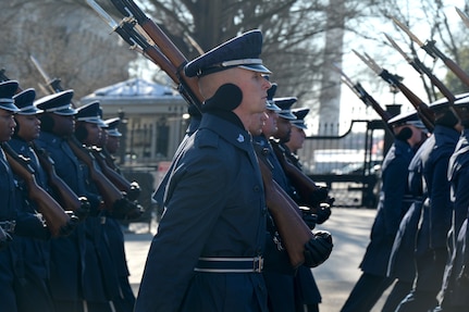 close up of row of Airmen marching holding rifles
