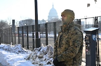 A Marine stands in cordon with U.S. Capitol in the background