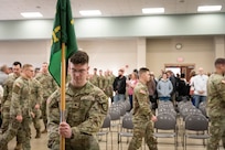 U.S. Army Spc. Tyler Pettibone, of the 617th Military Police Company, 149th Maneuver Enhancement Brigade, places the guidon at the deployment ceremony at the Armed Forces Reserve Center in Richmond, Kentucky, Jan. 4, 2025. Approximately 40 Soldiers with the 617th are deploying to the Middle East to support Operation Inherent Resolve.