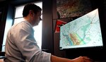 Computer Scientist Adam Moses run a scenario through the NRL 3D computer-simulated mapping and modeling program called CT-Analyst®