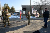 Chief Master Sgt. Kara West, former Senior Enlisted Leader for the 75th Logistics Readiness Squadron, and currently with the 21st Combat Air Base Squadron, prepares to cut a grounding cable held by Airman 1st Class Bertran Celerino Da Silva and Kevin Tippetts, 75th LRS, to mark the reopening of the Fuel Management Flight's building on Jan. 16, 2025, at Hill Air Force Base, Utah. Originally constructed in the 1950s, the Fuels Management Flight's building underwent a 10-month renovation that eradicated asbestos, and overhauled bathrooms, kitchen HVAC system, fire suppression system, doors and windows. During the construction period, the flight continued 24/7 mission support from an alternate location.
